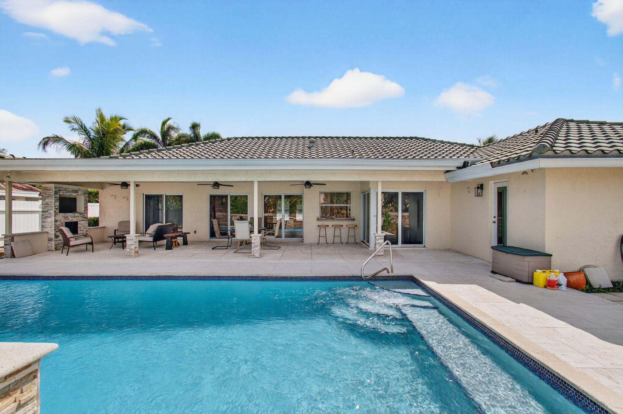 6063 Golf Vista Way Boca Raton, FL 33433 - Photo 46 of 52 a front view of a house with swimming pool having outdoor seating