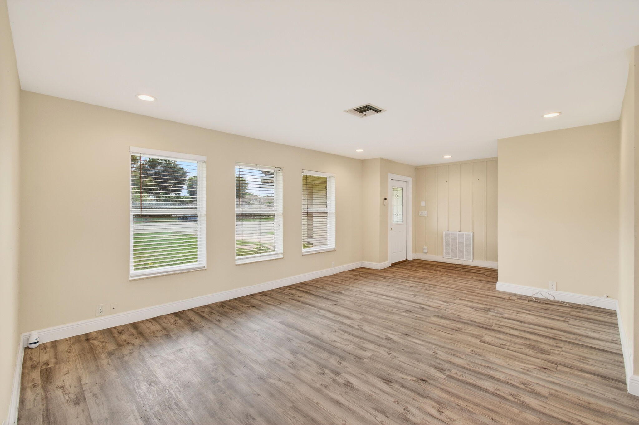 6063 Golf Vista Way Boca Raton, FL 33433 - Photo 10 of 52 a view of an empty room with wooden floor and a window