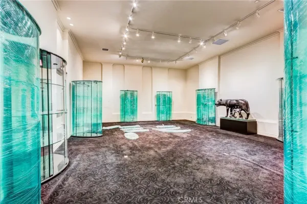 a living room with a table chairs and a large window
