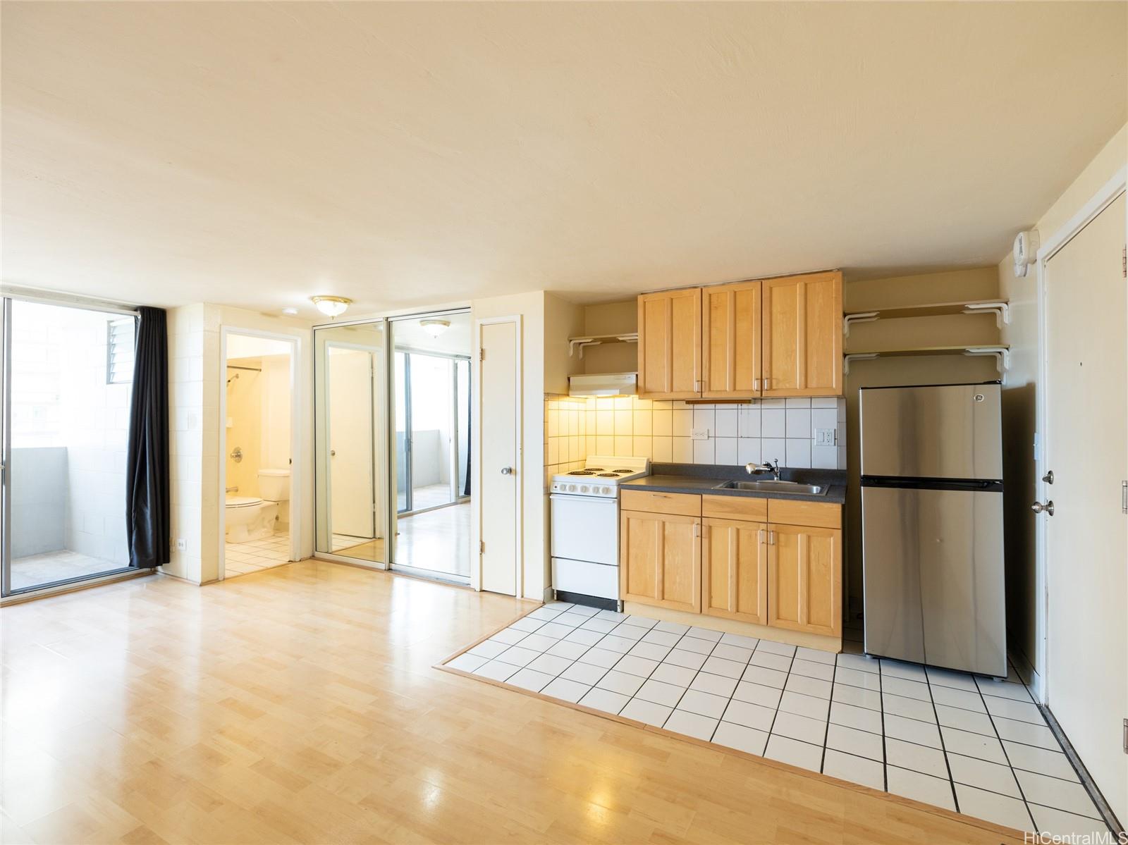 824 Kinau Street, Unit 1006 Honolulu, HI 96813 - Photo 1 of 1 a kitchen with a refrigerator and a stove top oven