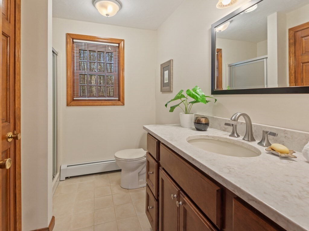 532 B Hubbardston Road Princeton, MA 01541 - Photo 15 of 41 a bathroom with a granite countertop toilet sink and mirror