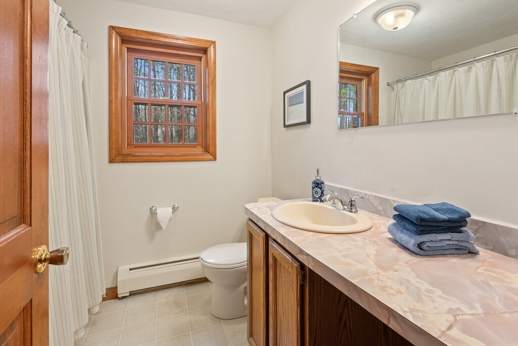 532 B Hubbardston Road Princeton, MA 01541 - Photo 22 of 41 a bathroom with a granite countertop sink a toilet and a mirror