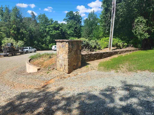 a view of a wooden fence next to a road