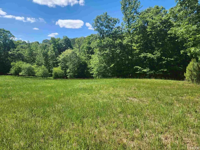 a view of a garden with a house