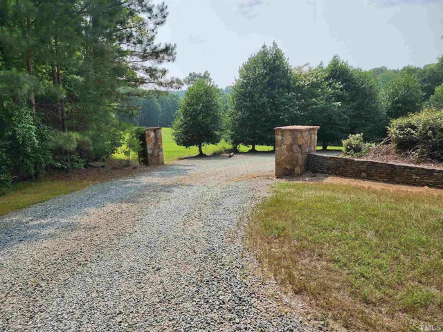 a view of a field with trees in the background