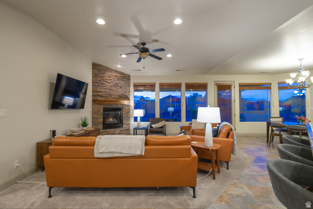 2212 Chippenham Court St. George, UT 84770 - Photo 8 of 75 Living area with a fireplace, stone finish flooring, a ceiling fan, and a chandelier