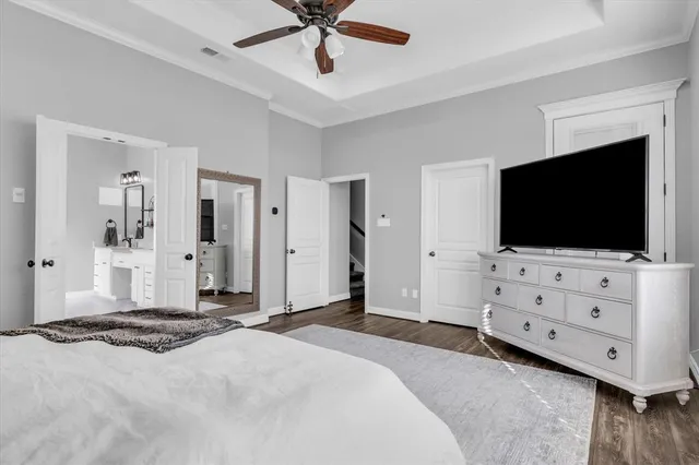 a bedroom with furniture and flat screen tv