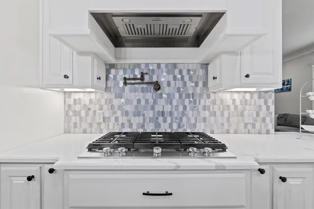 a stove top oven sitting inside of a kitchen