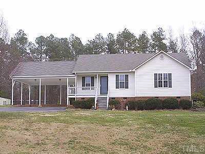 4109 Rockside Hills Drive Raleigh, NC 27603 - Photo 1 of 1 a front view of a house with a garden