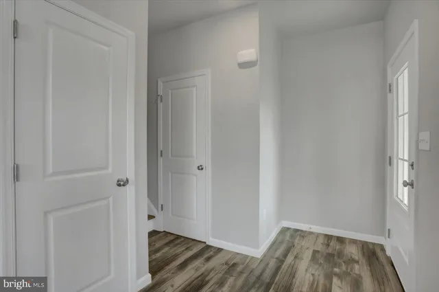 a view of kitchen with wooden floor electronic appliances and window