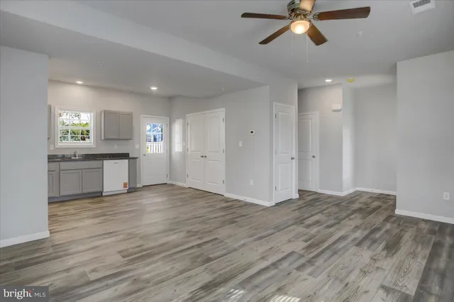a kitchen with white cabinets stainless steel appliances and window