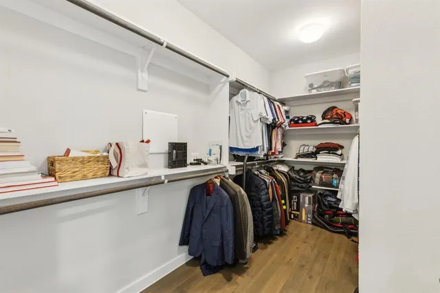 a view of walk in closet with clothes and shoes