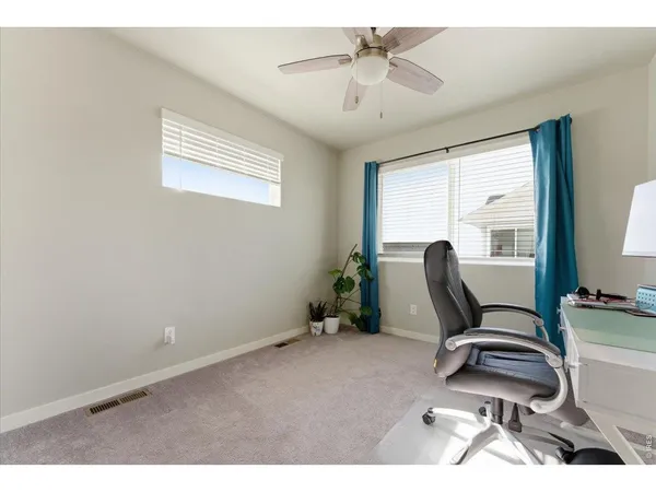 a workspace room with furniture and wooden floor