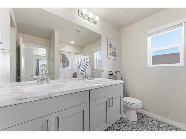 a bathroom with a sink vanity and a mirror