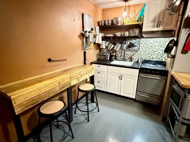 a kitchen with stainless steel appliances a sink and a stove