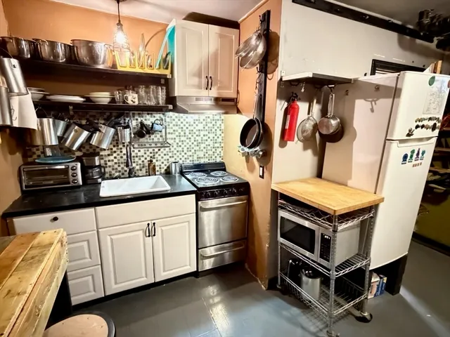 a kitchen with stainless steel appliances a stove a microwave and a refrigerator
