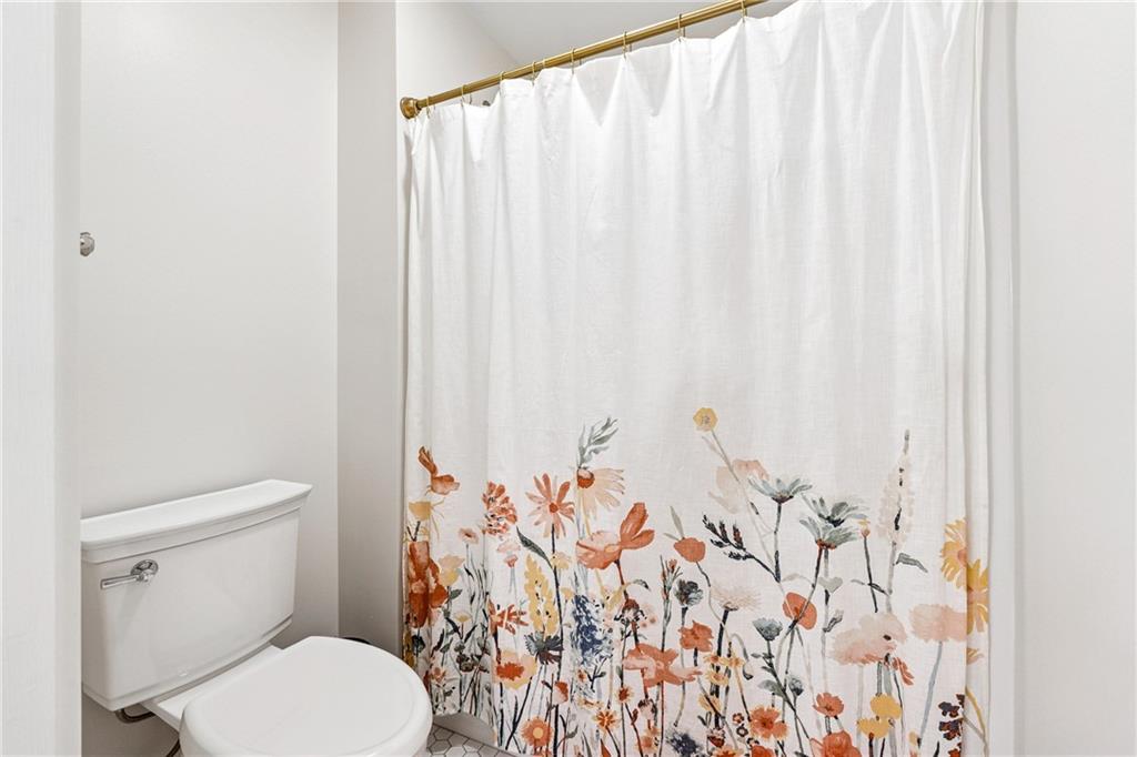 38 Mountain Ridge Road Northeast White, GA 30184 - Photo 45 of 79 a white toilet sitting next to a shower curtain
