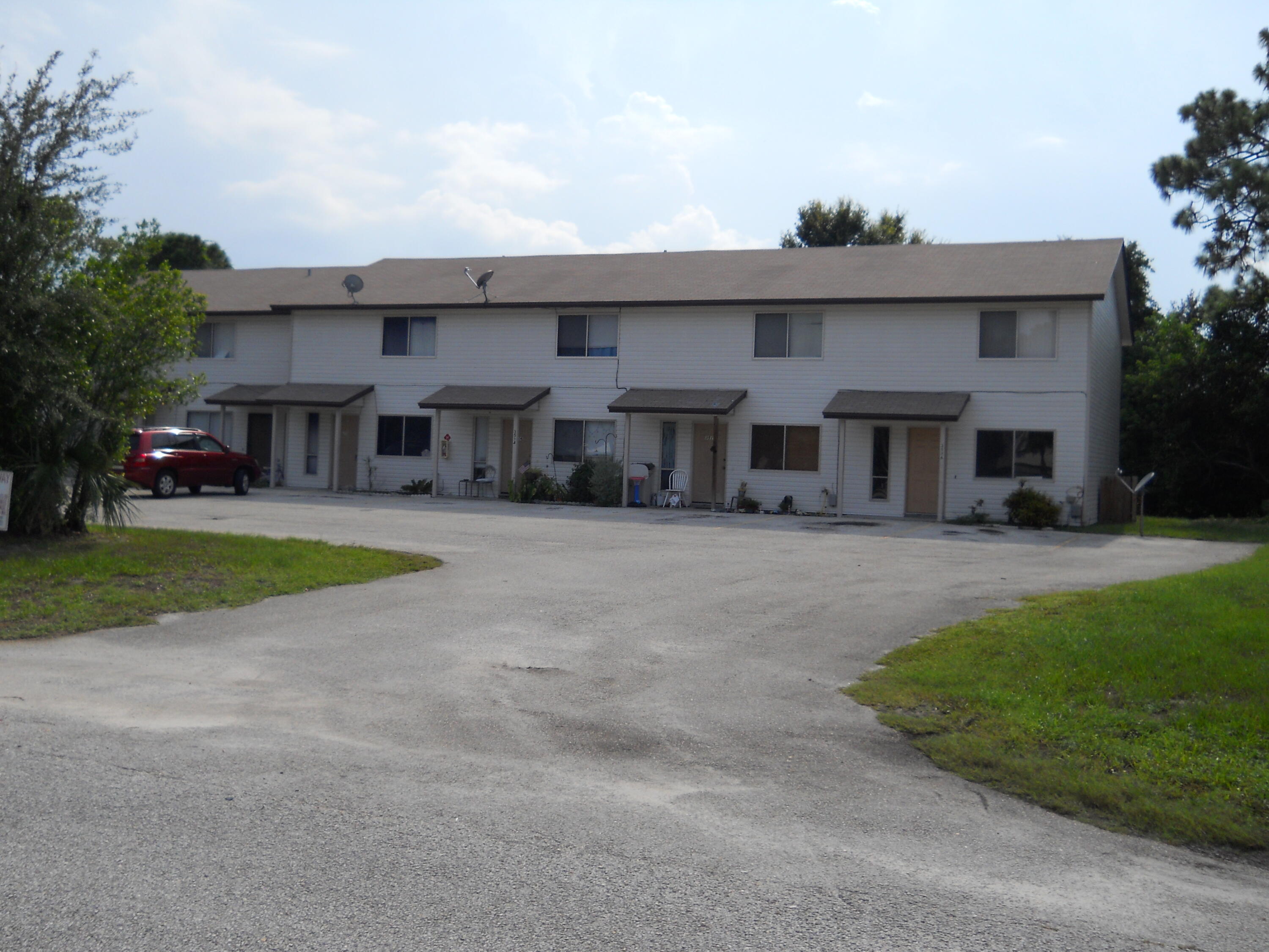 3513 Tree Ridge Lane Northeast Palm Bay, FL 32905 - Photo 2 of 16 a view of house with outdoor space and tree s