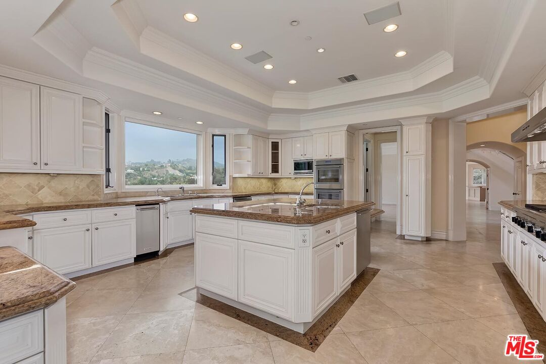 11971 Lockridge Road Studio City, CA 91604 - Photo 13 of 31 a kitchen with granite countertop a sink stove and refrigerator