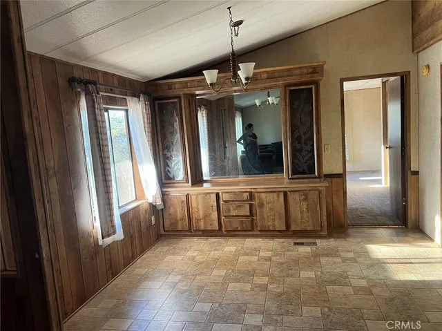 a kitchen with kitchen island granite countertop a sink and a refrigerator