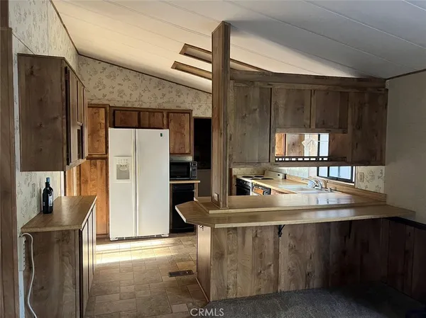 a kitchen with stainless steel appliances granite countertop a stove and a refrigerator