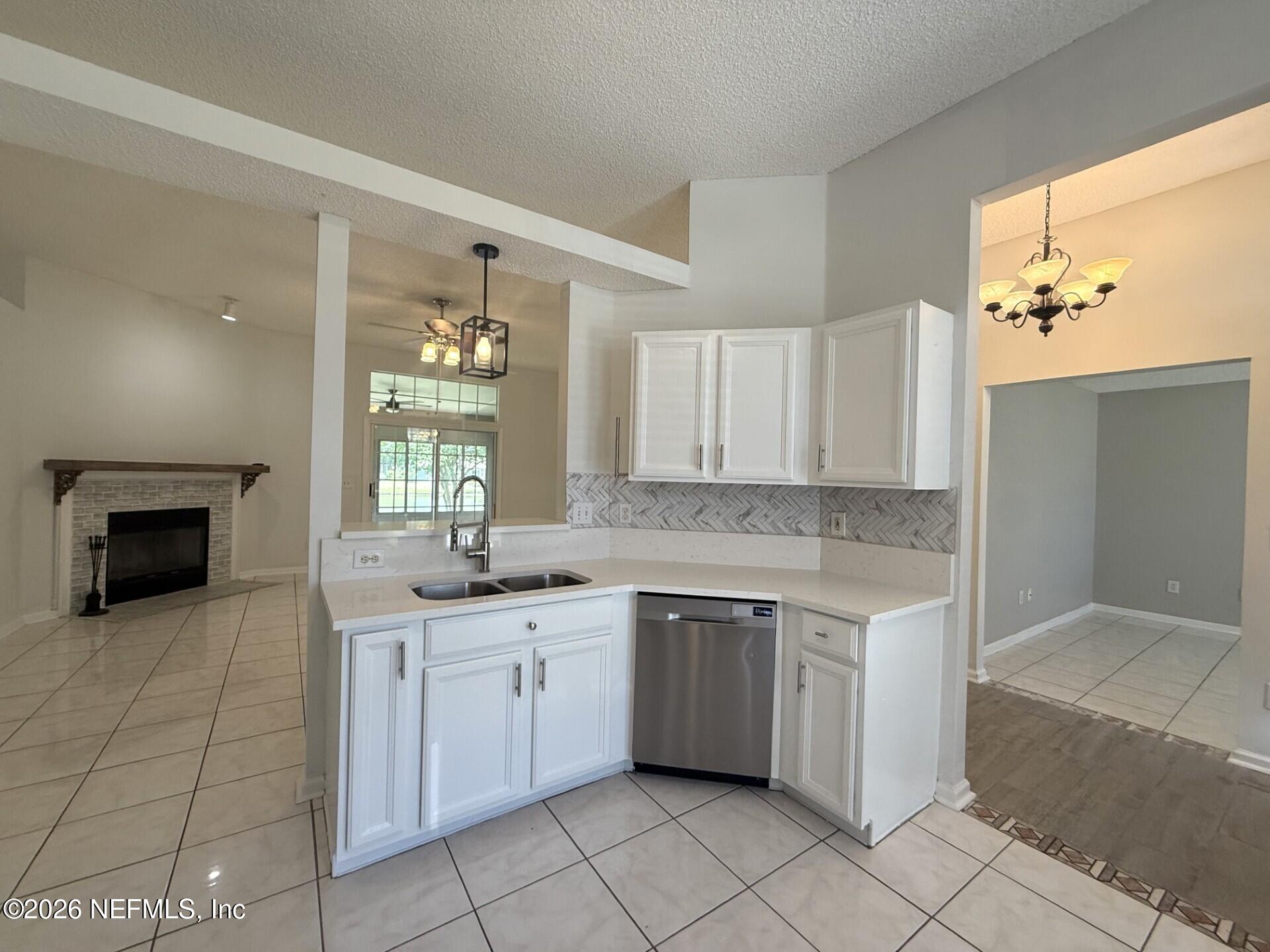 913 Mackinaw Trail St. Augustine, FL 32092 - Photo 25 of 65 a kitchen with a sink stove and cabinets