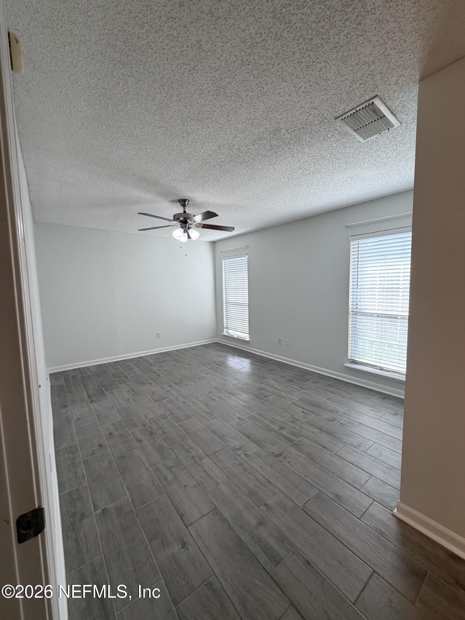 913 Mackinaw Trail St. Augustine, FL 32092 - Photo 33 of 65 an empty room with wooden floor fan and windows