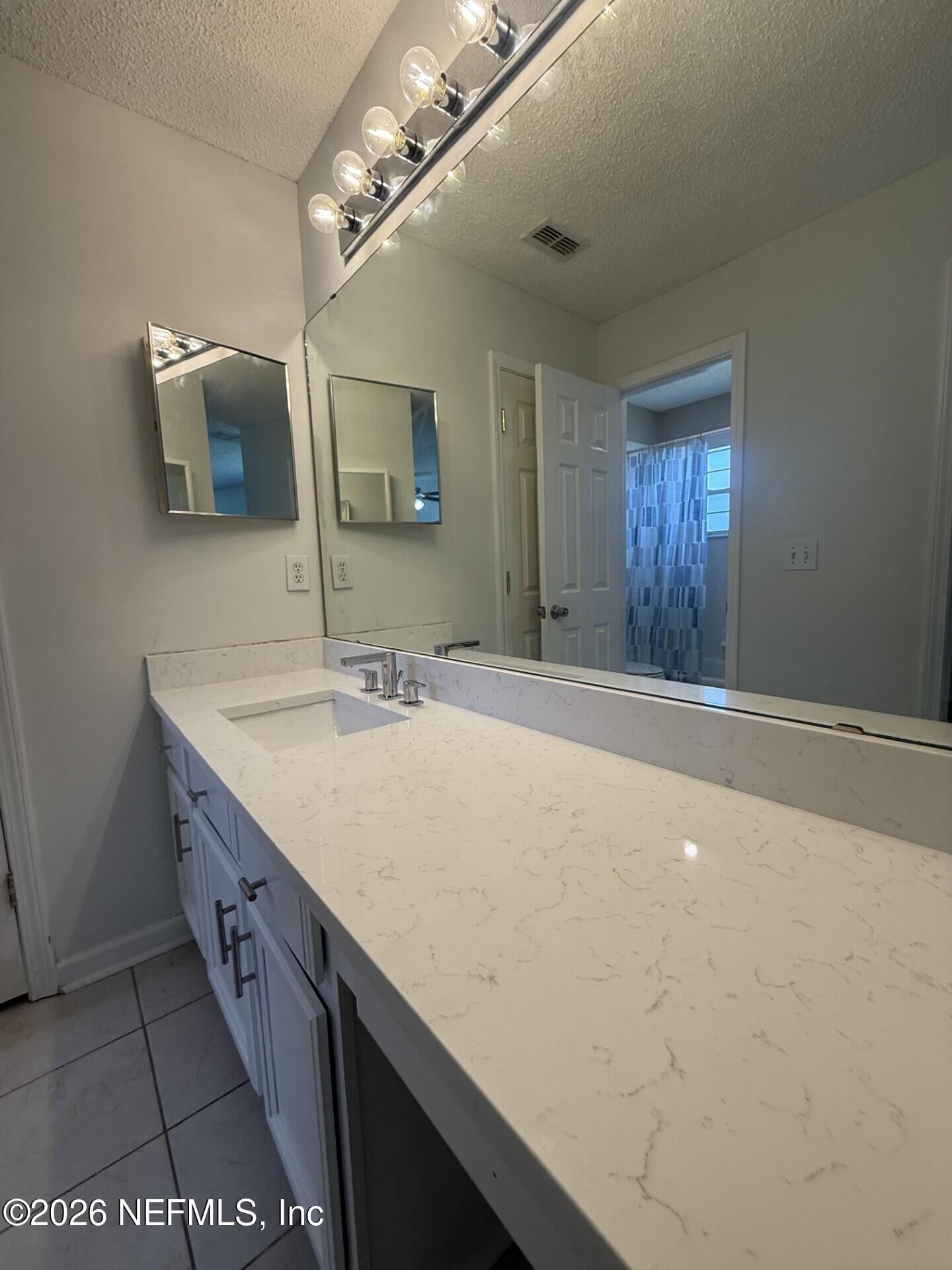 913 Mackinaw Trail St. Augustine, FL 32092 - Photo 34 of 65 a bathroom with a sink a vanity and a mirror