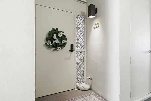 a vase of flowers sitting on a shelf