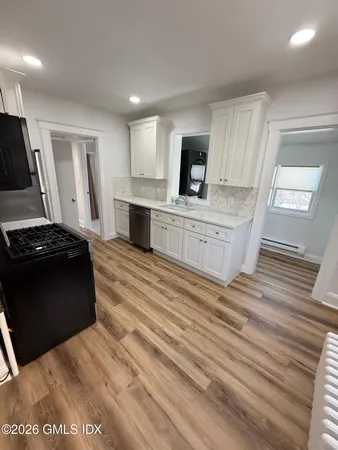 a large kitchen with a stove and a sink