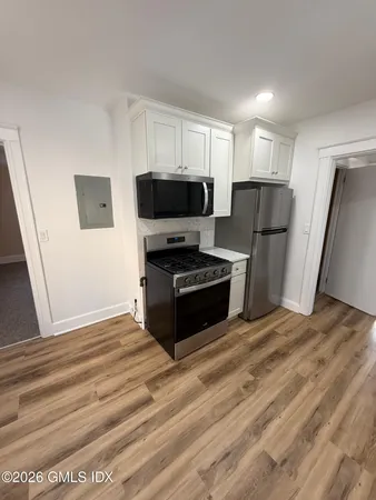 a kitchen with a refrigerator sink and cabinets