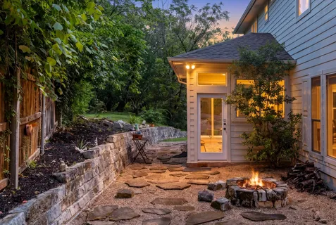 a backyard of a house with yard and outdoor seating
