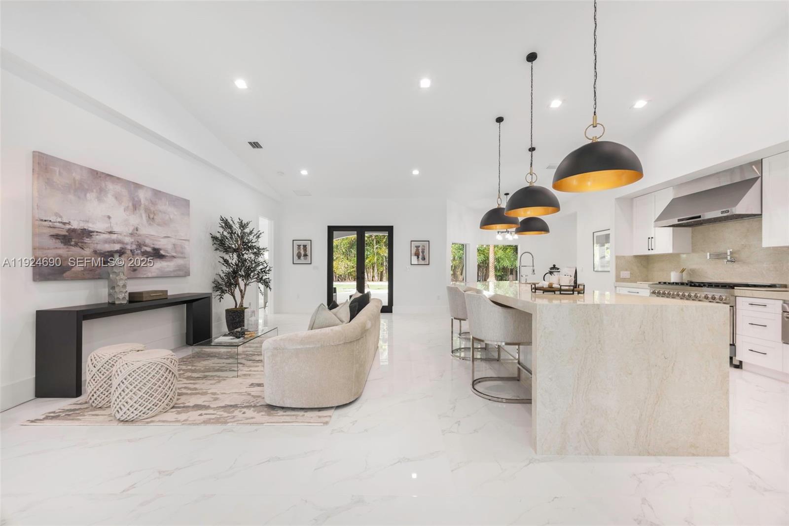 a living room with fireplace furniture and a chandelier