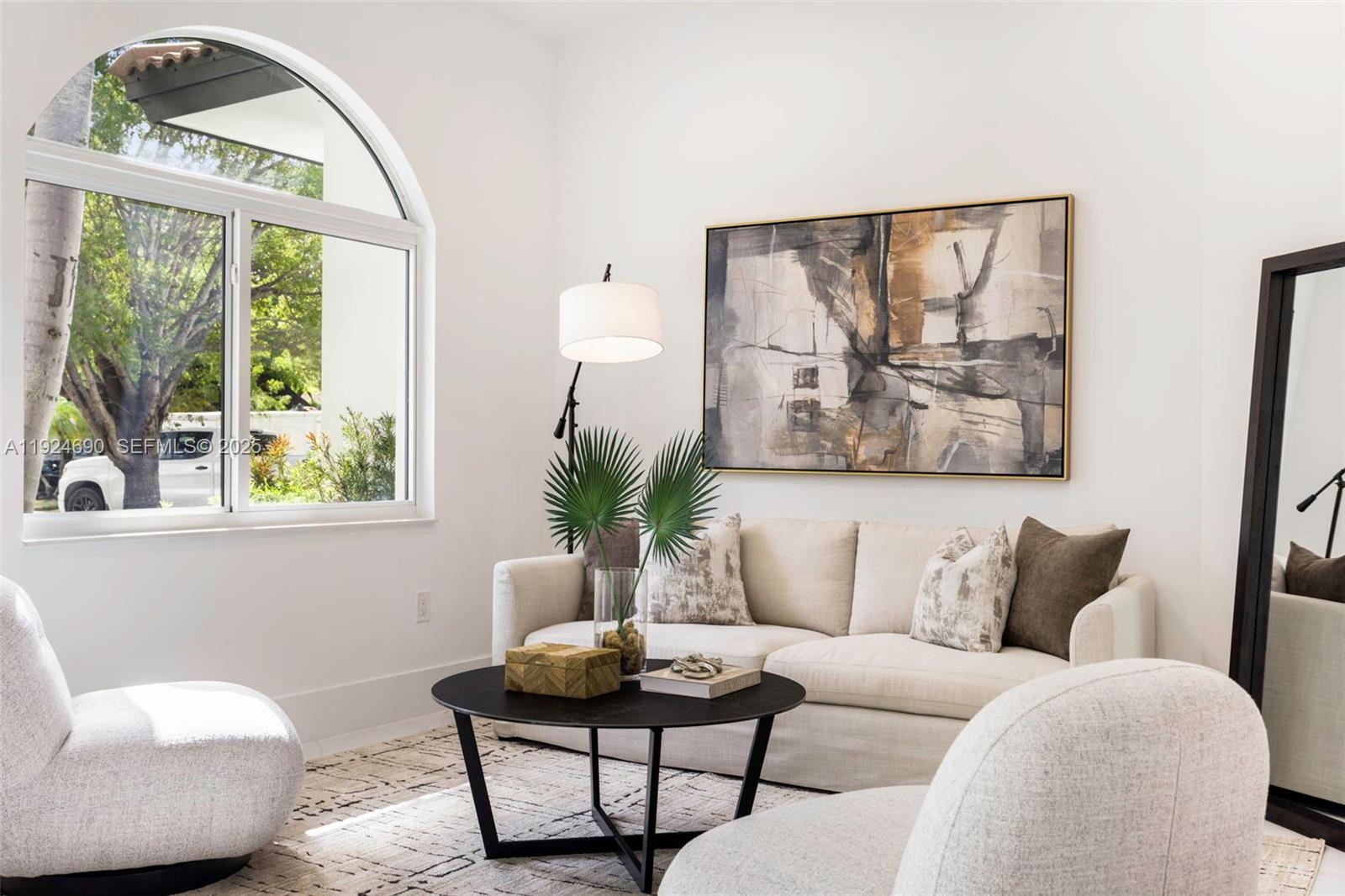 6845 Southwest 52nd Street Miami, FL 33155 - Photo 11 of 39 a living room with furniture and a large window