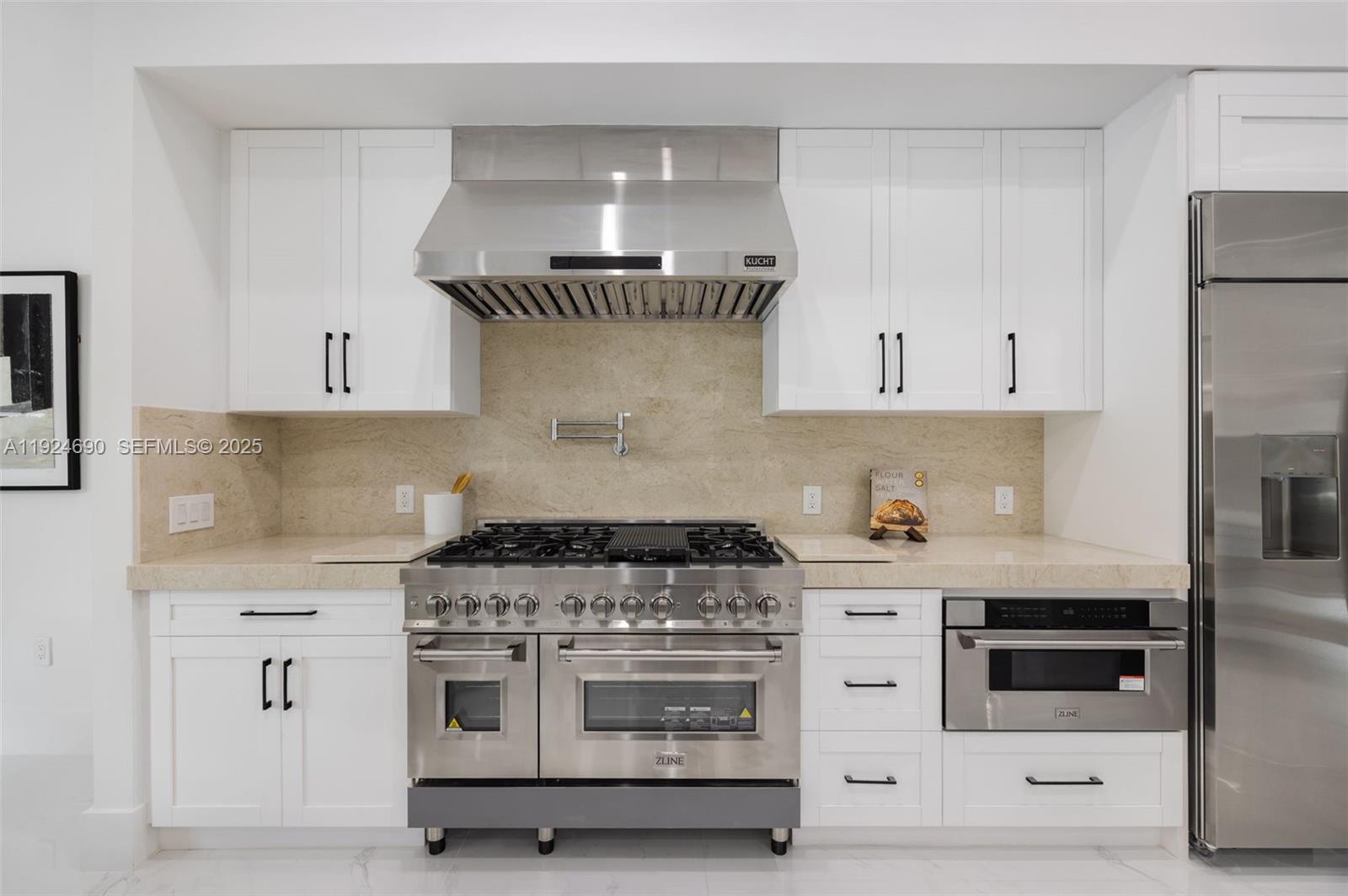 6845 Southwest 52nd Street Miami, FL 33155 - Photo 14 of 39 a kitchen with white cabinets and white appliances
