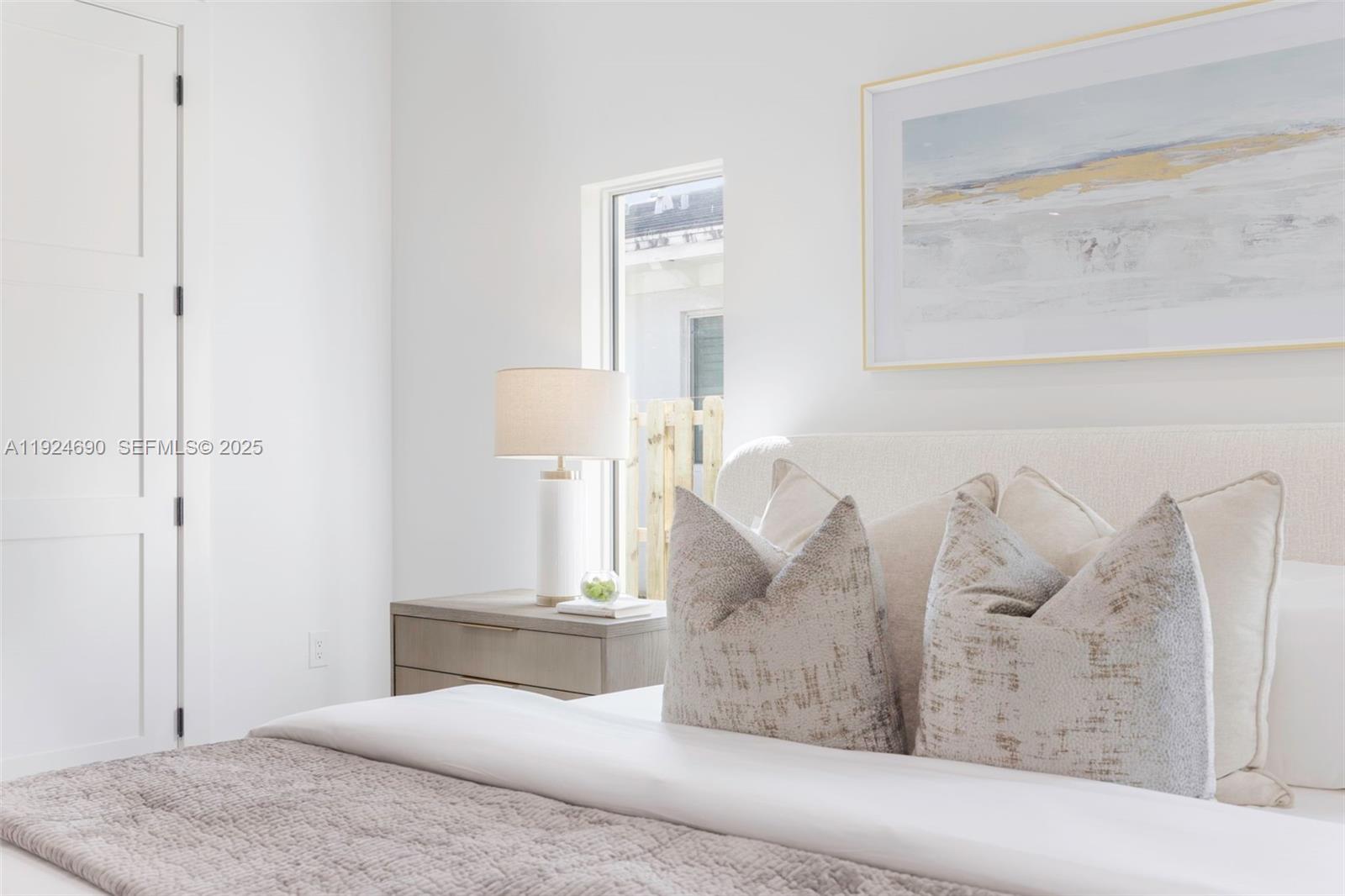 6845 Southwest 52nd Street Miami, FL 33155 - Photo 16 of 39 a bedroom with a large bed and a chandelier