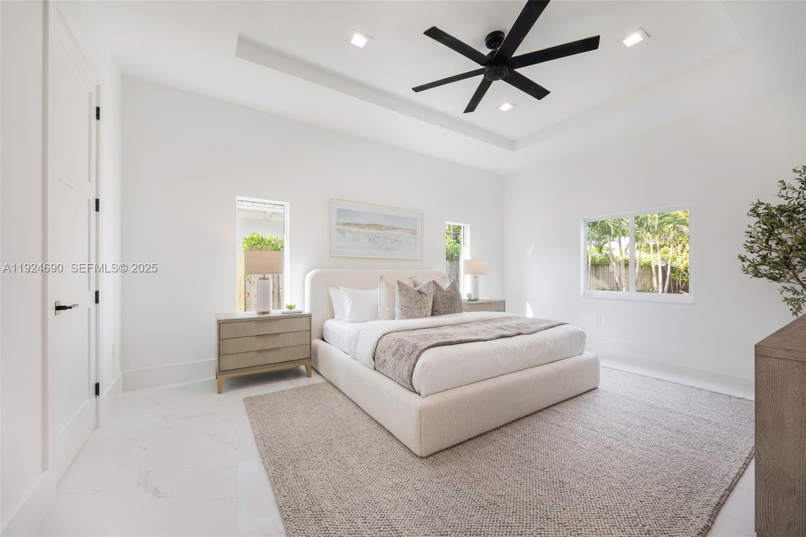 6845 Southwest 52nd Street Miami, FL 33155 - Photo 17 of 39 a bedroom with a bed and a chandelier