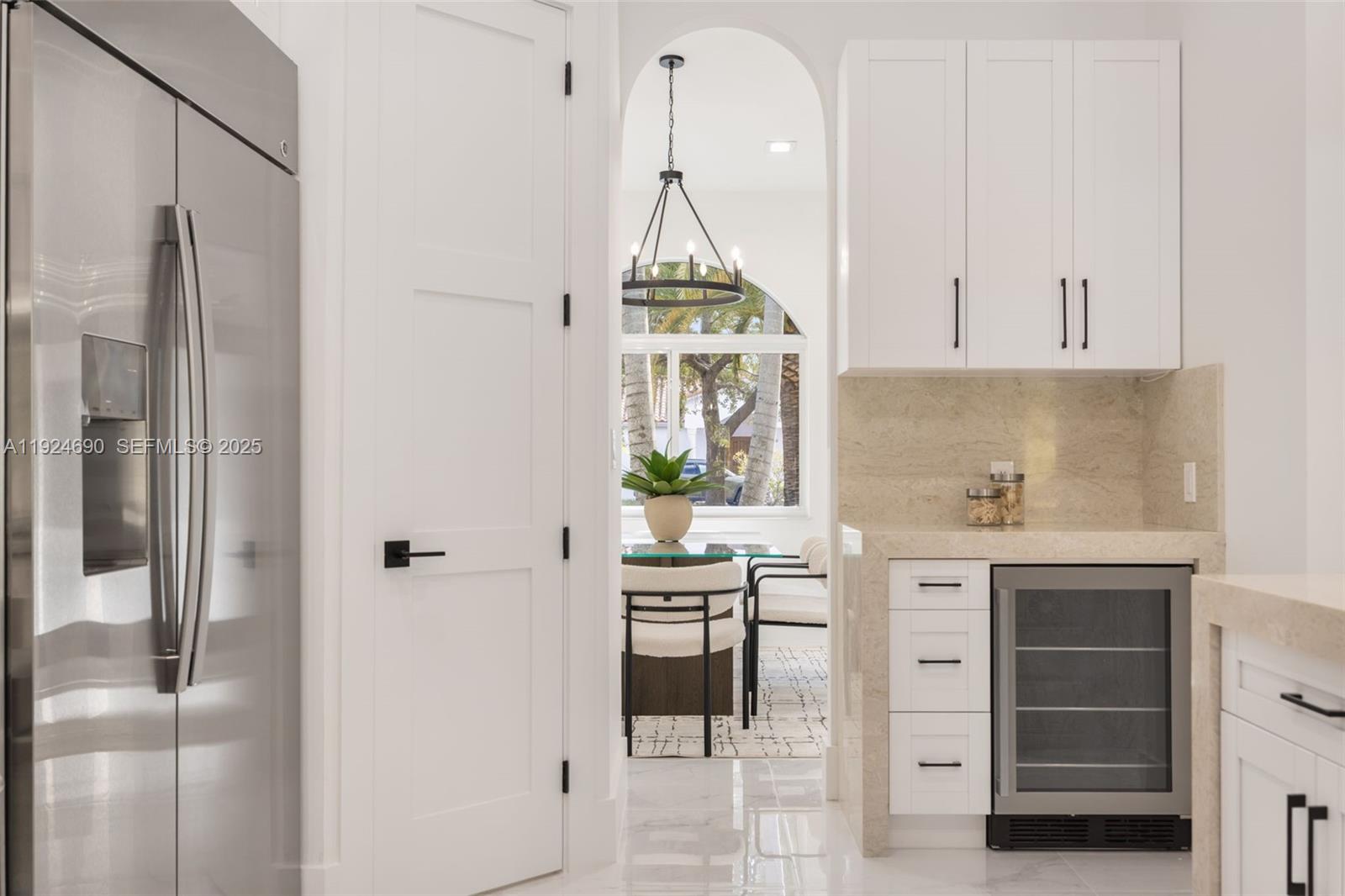 6845 Southwest 52nd Street Miami, FL 33155 - Photo 19 of 39 a kitchen with kitchen island a counter top space a sink stainless steel appliances and cabinets