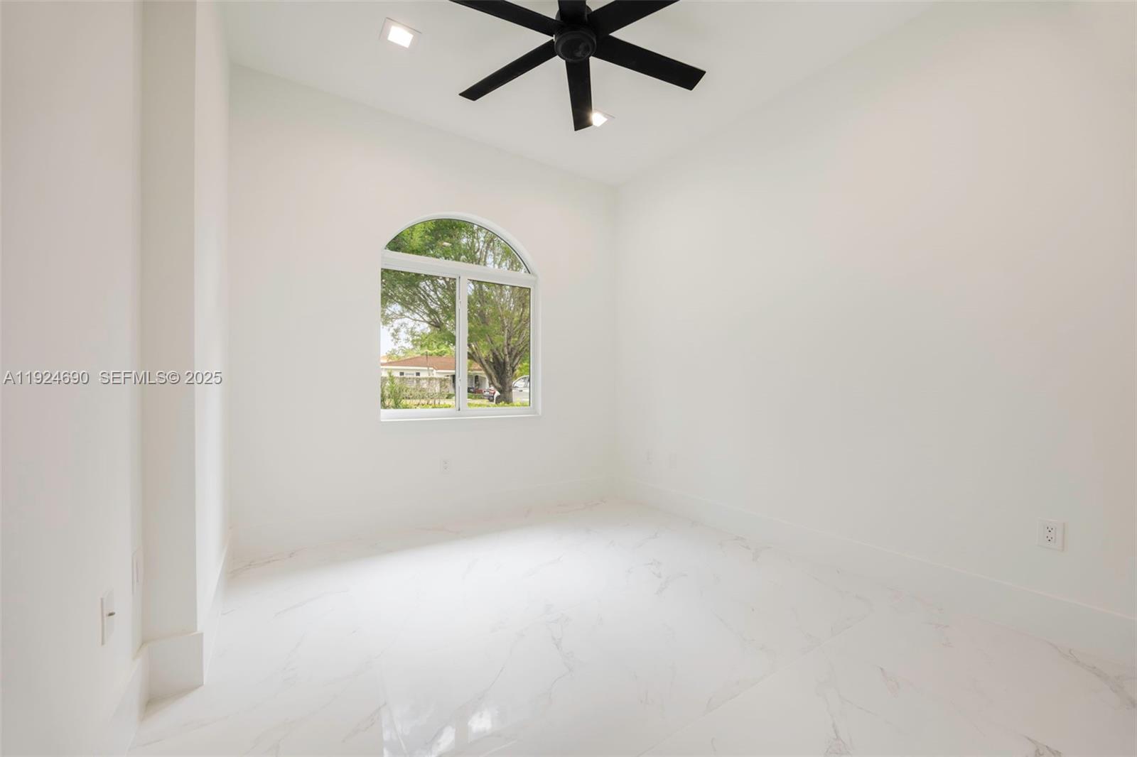 6845 Southwest 52nd Street Miami, FL 33155 - Photo 20 of 39 an empty room with windows and fan