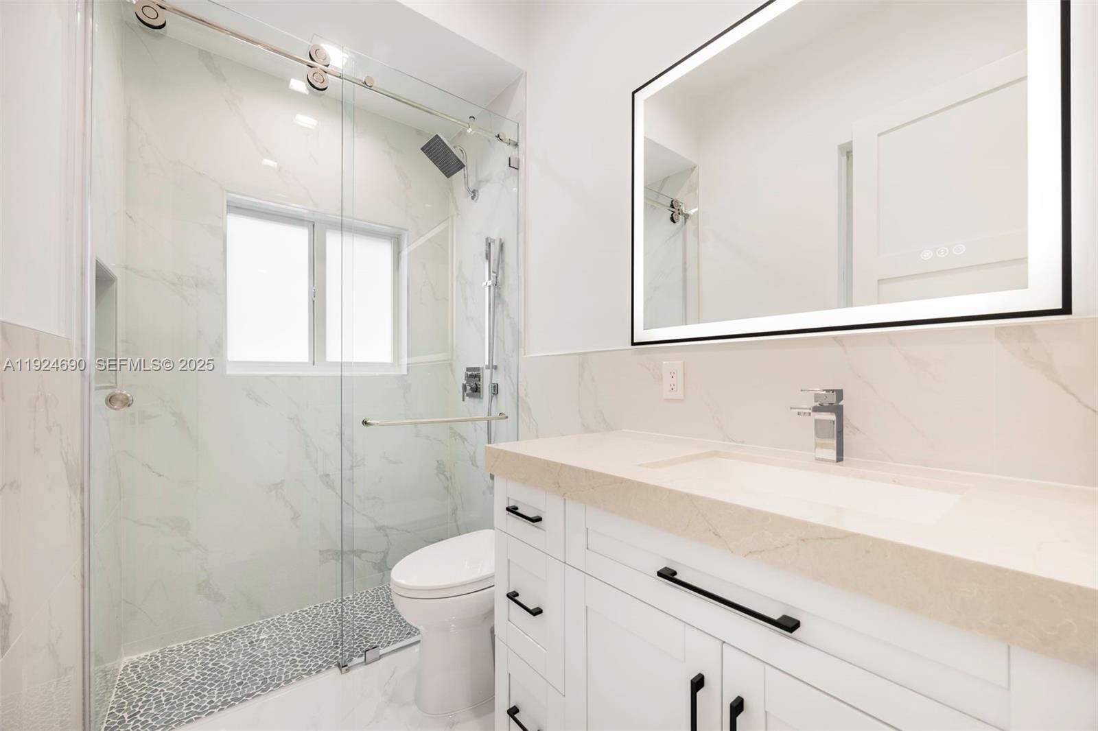 6845 Southwest 52nd Street Miami, FL 33155 - Photo 24 of 39 a bathroom with a sink a toilet and shower