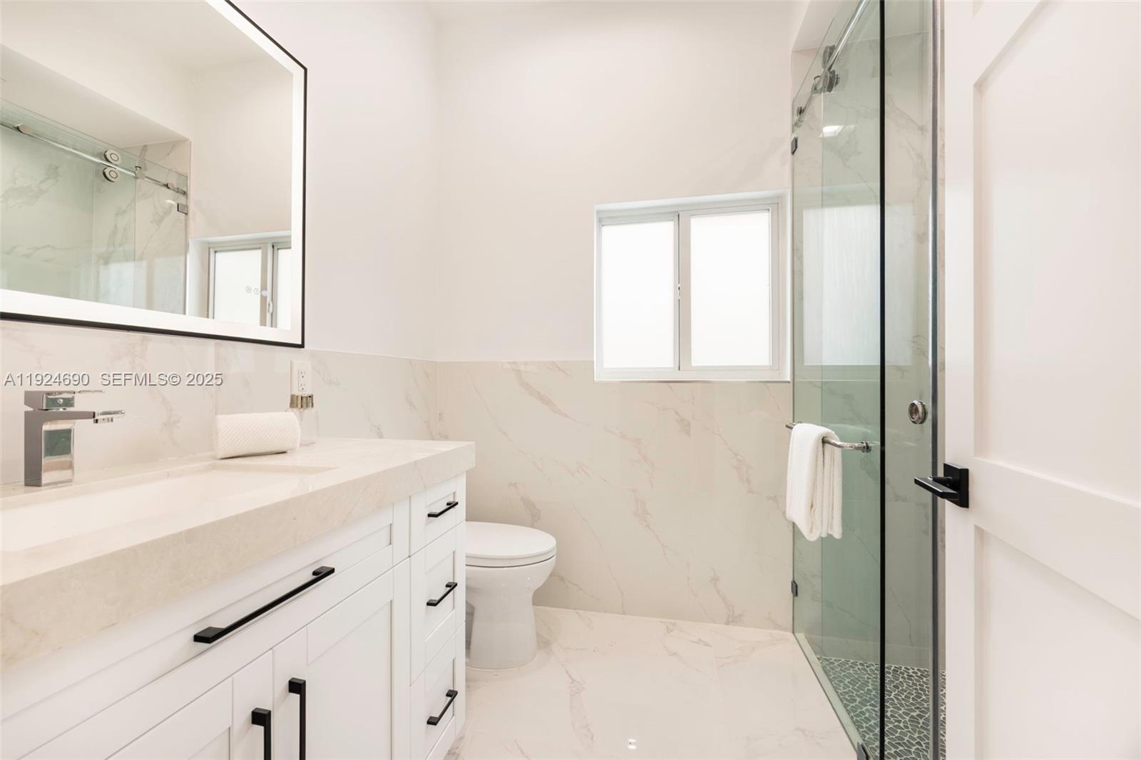 6845 Southwest 52nd Street Miami, FL 33155 - Photo 25 of 39 a bathroom with a sink a toilet and shower