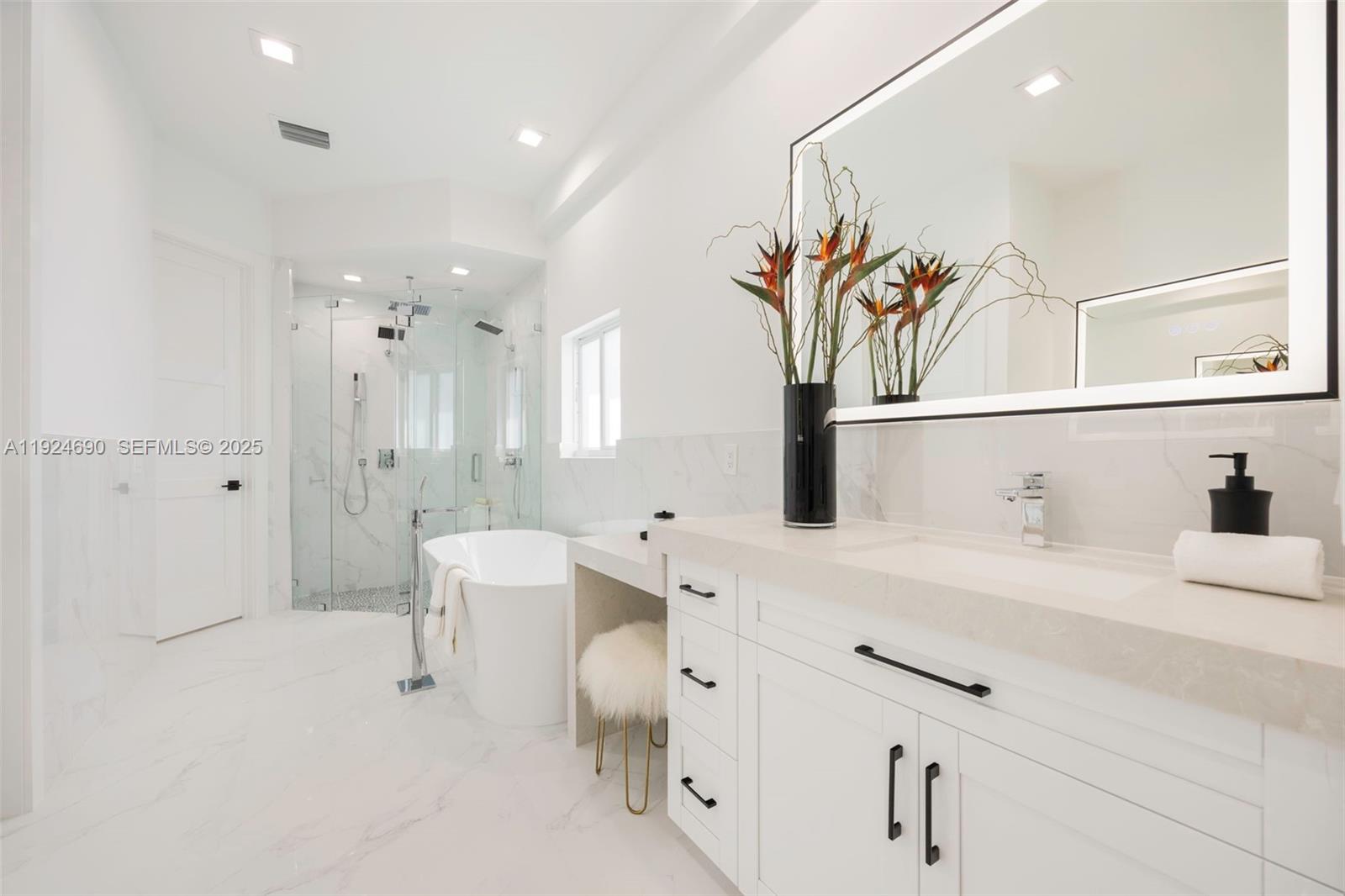 6845 Southwest 52nd Street Miami, FL 33155 - Photo 29 of 39 a bathroom with a sink a mirror and a shower