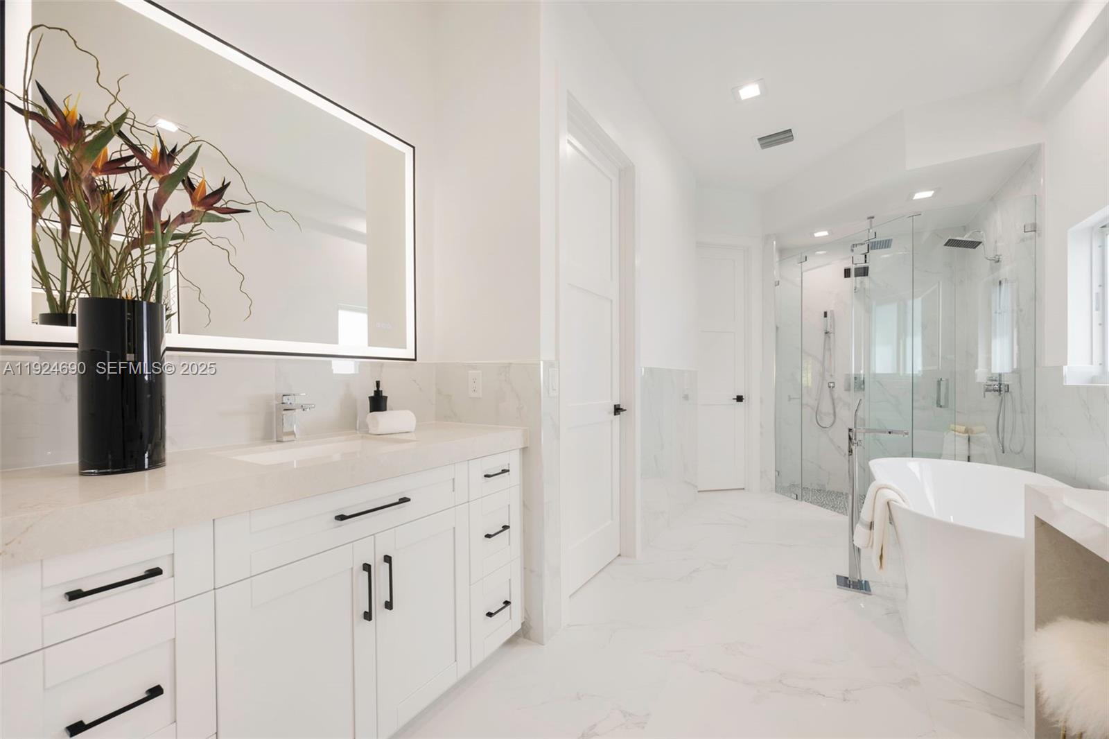 6845 Southwest 52nd Street Miami, FL 33155 - Photo 30 of 39 a bathroom with a double vanity sink toilet and shower