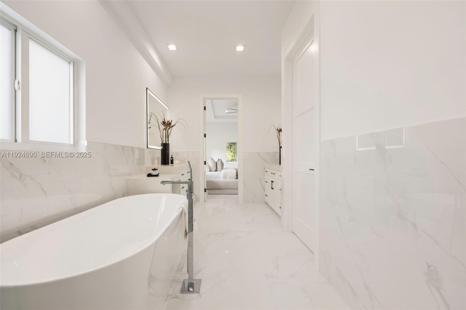 6845 Southwest 52nd Street Miami, FL 33155 - Photo 31 of 39 a spacious bathroom with a bathtub and a sink