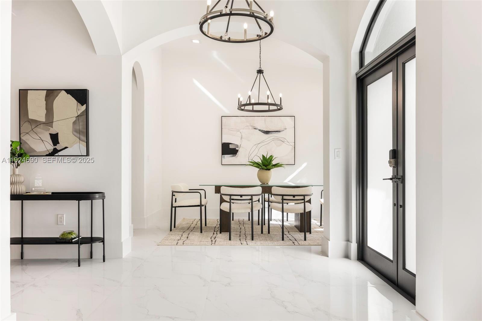 6845 Southwest 52nd Street Miami, FL 33155 - Photo 5 of 39 a view of hall way with furniture and chandelier