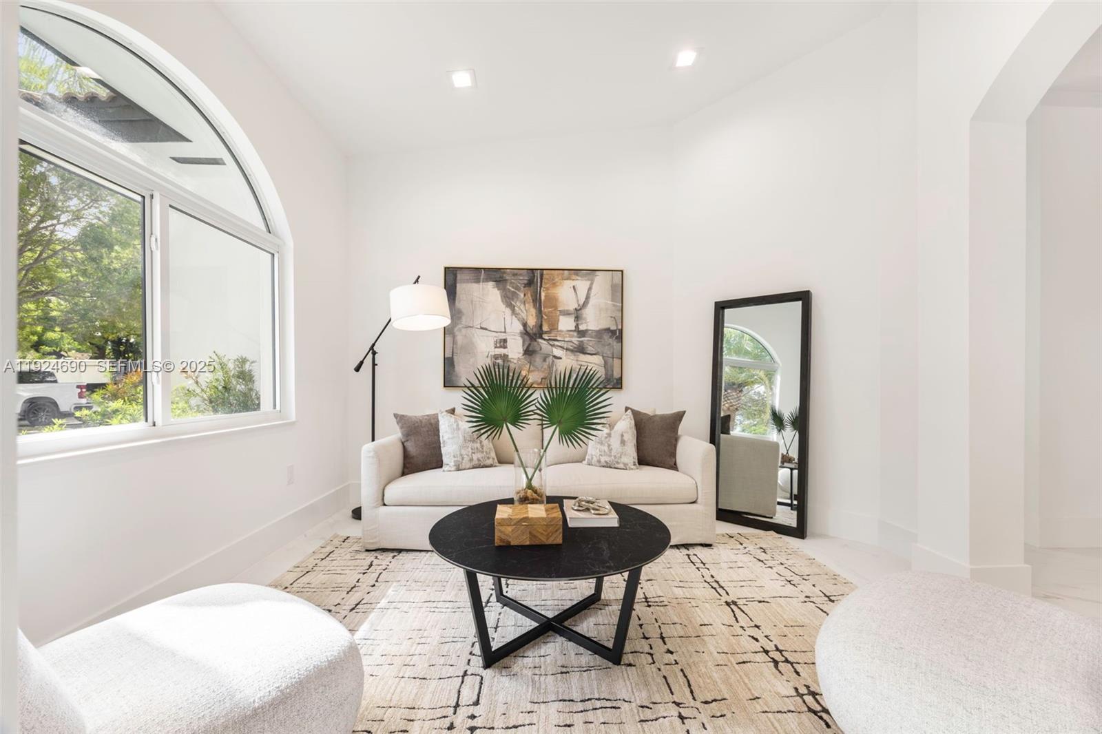 6845 Southwest 52nd Street Miami, FL 33155 - Photo 8 of 39 a living room with furniture and a large window