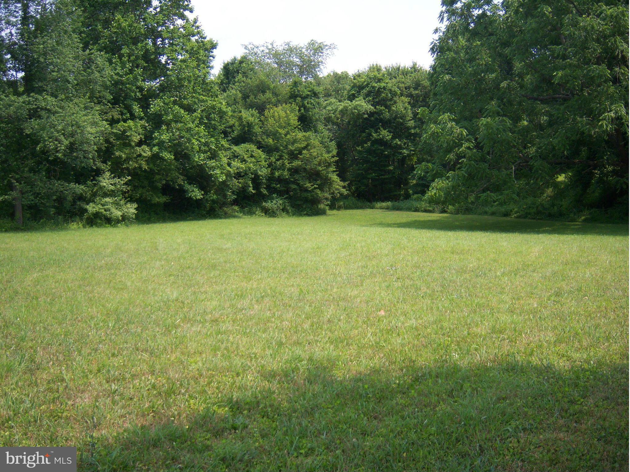 Indian Spring Sparks, MD 21152 - Photo 5 of 9 a view of a field with a trees in the background