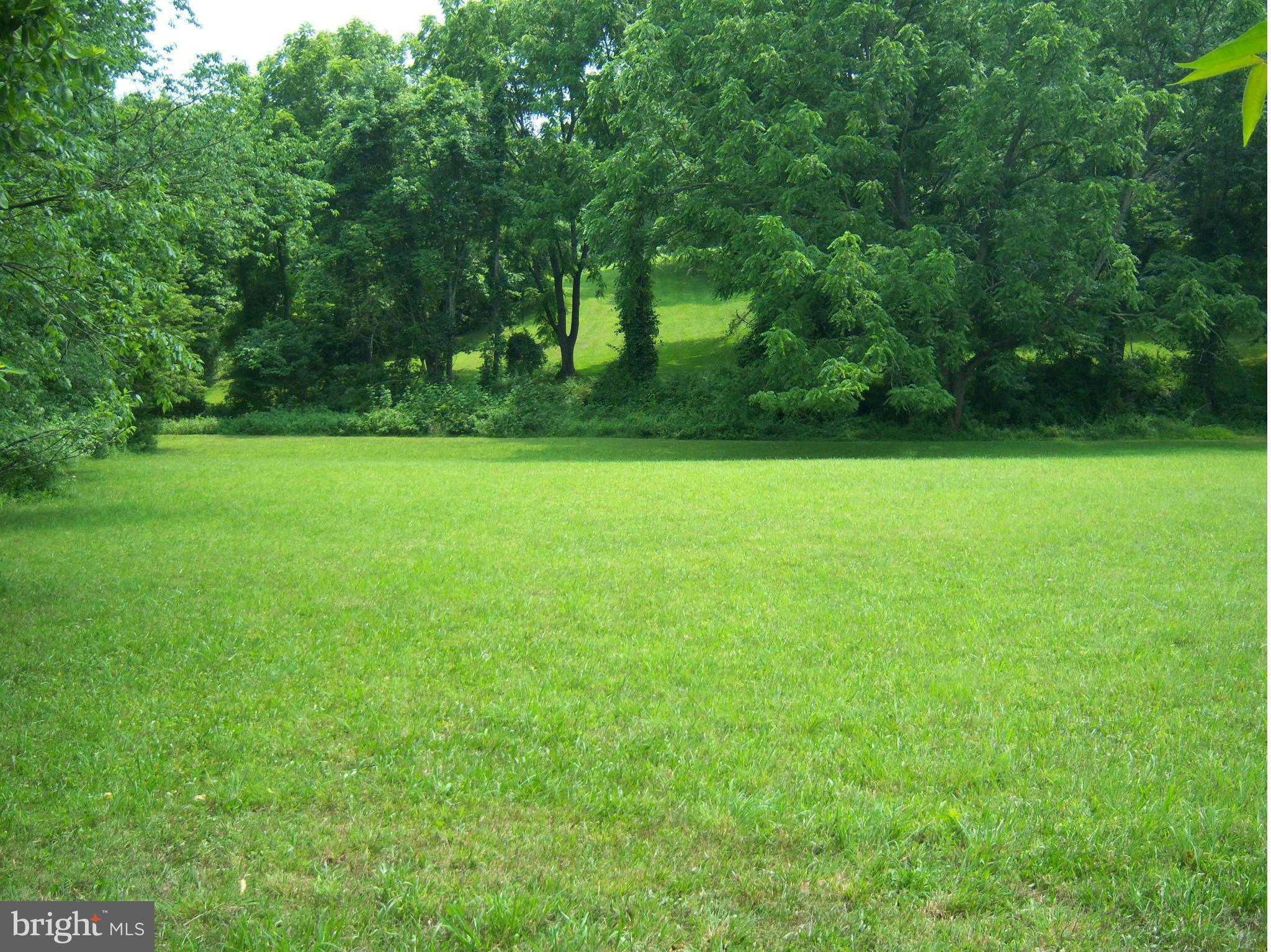 Indian Spring Sparks, MD 21152 - Photo 7 of 9 a view of a field of grass and trees