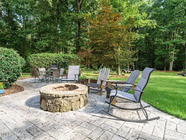 an aerial view of a house with a yard and a large tree