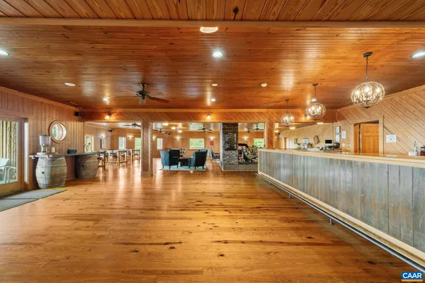 a dining room with furniture entryway and wooden floor